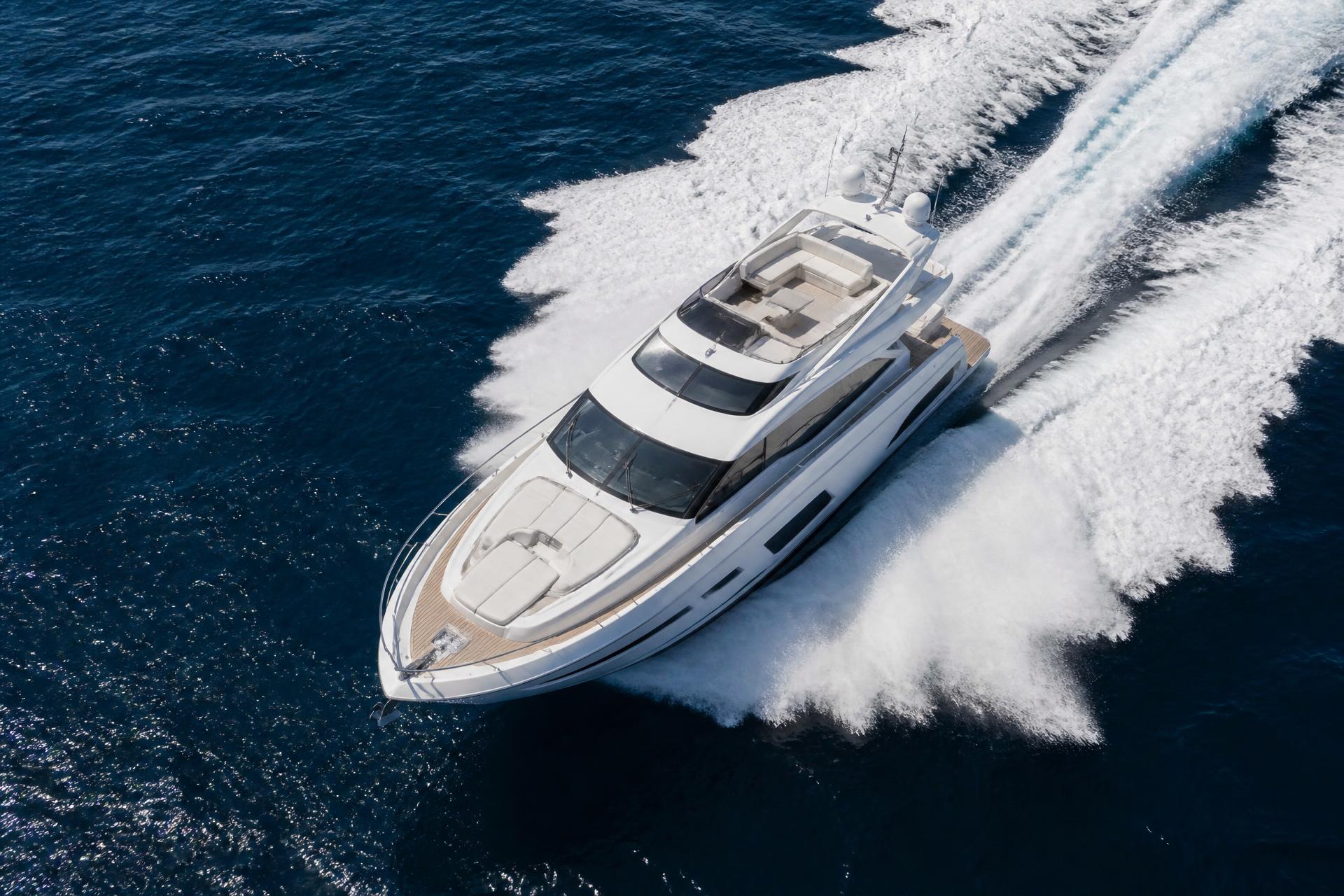 Motor yacht running at speed across open water
